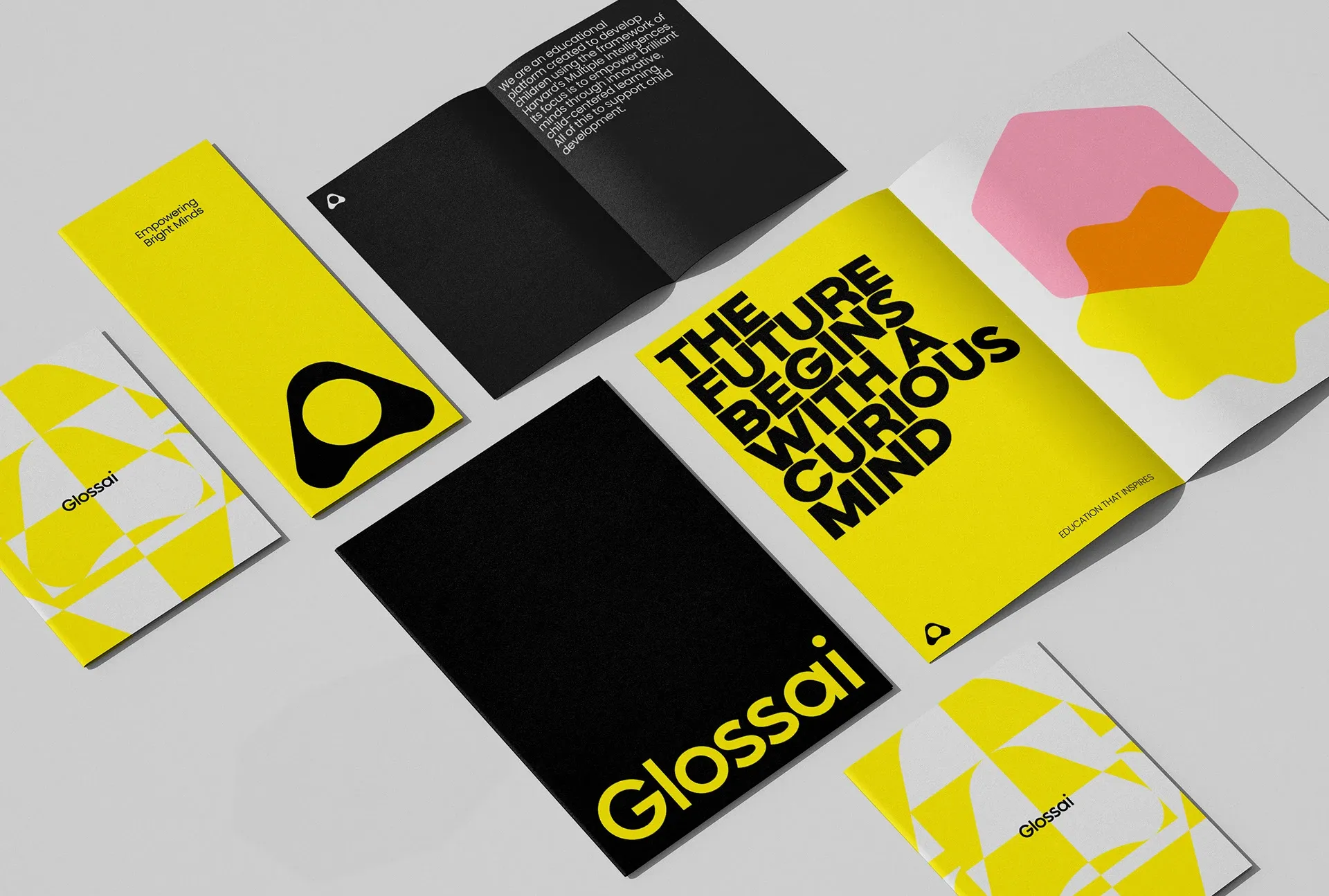 Image 2: Glossai children's branding print collateral system - scatter of booklets and brochures