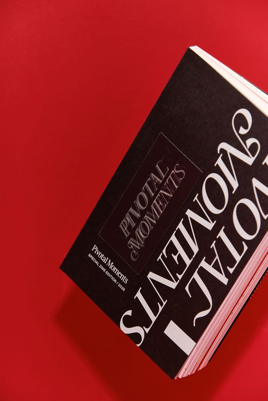 Image 2: Close-up of the book spine and textured paper used in the Pivotal Moments editorial design project.