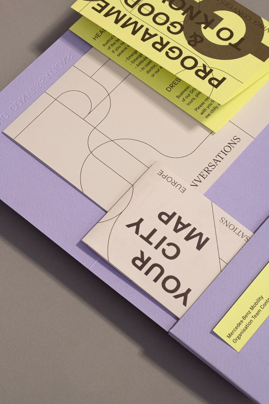 Image 8: tactile design showing the texture of the paper and the visual identity fold patterns