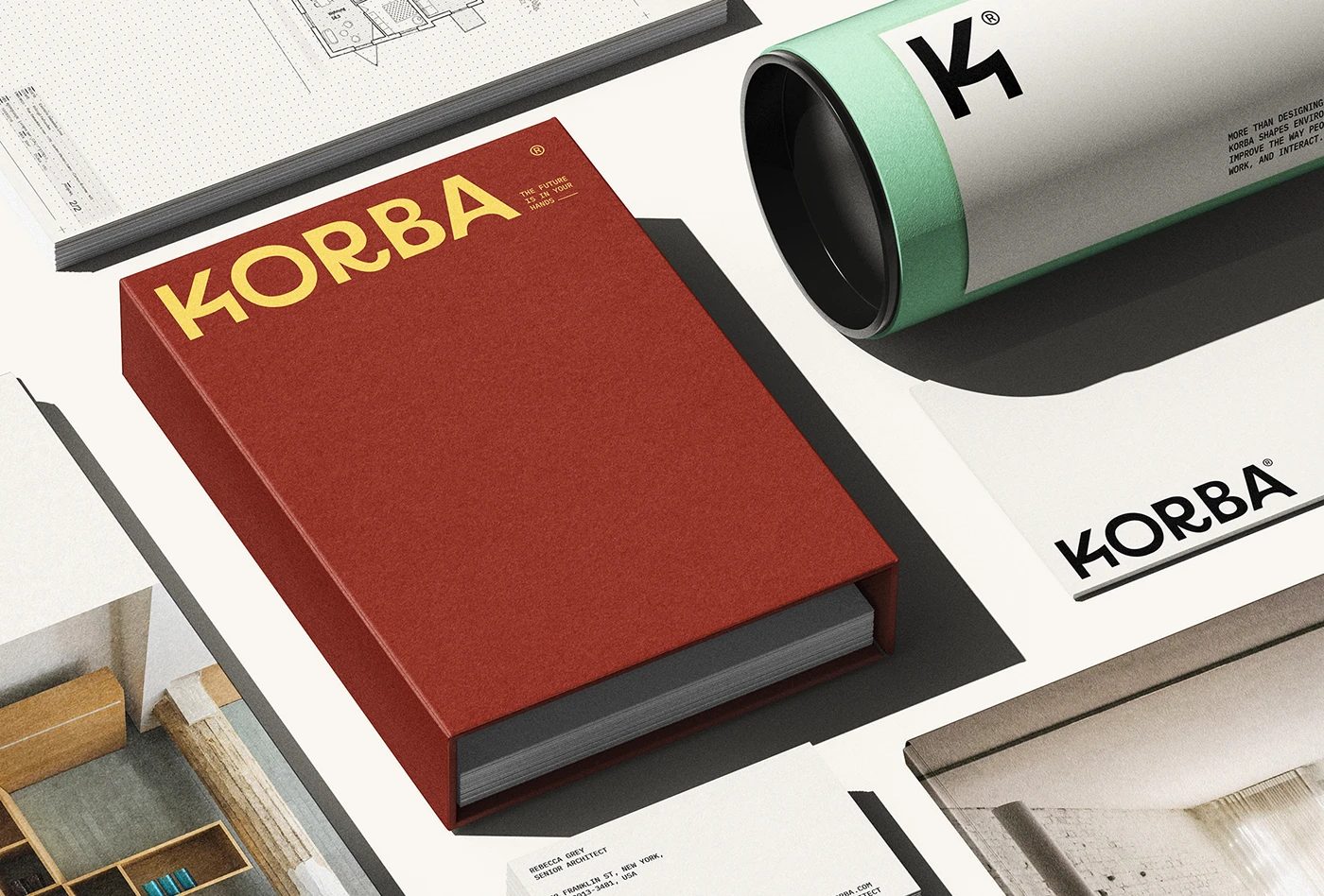 Image 7: KORBA architectural studio branding red book cover and mint shipping tube