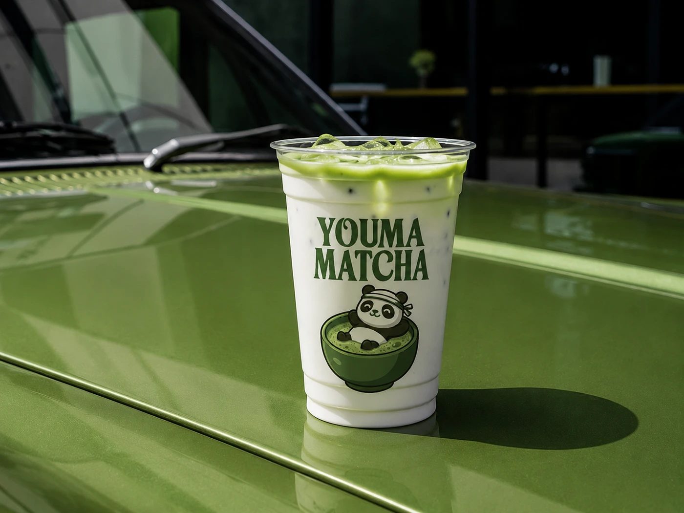 Image 2: Youma Matcha branding iced beverage cup on green bonnet
