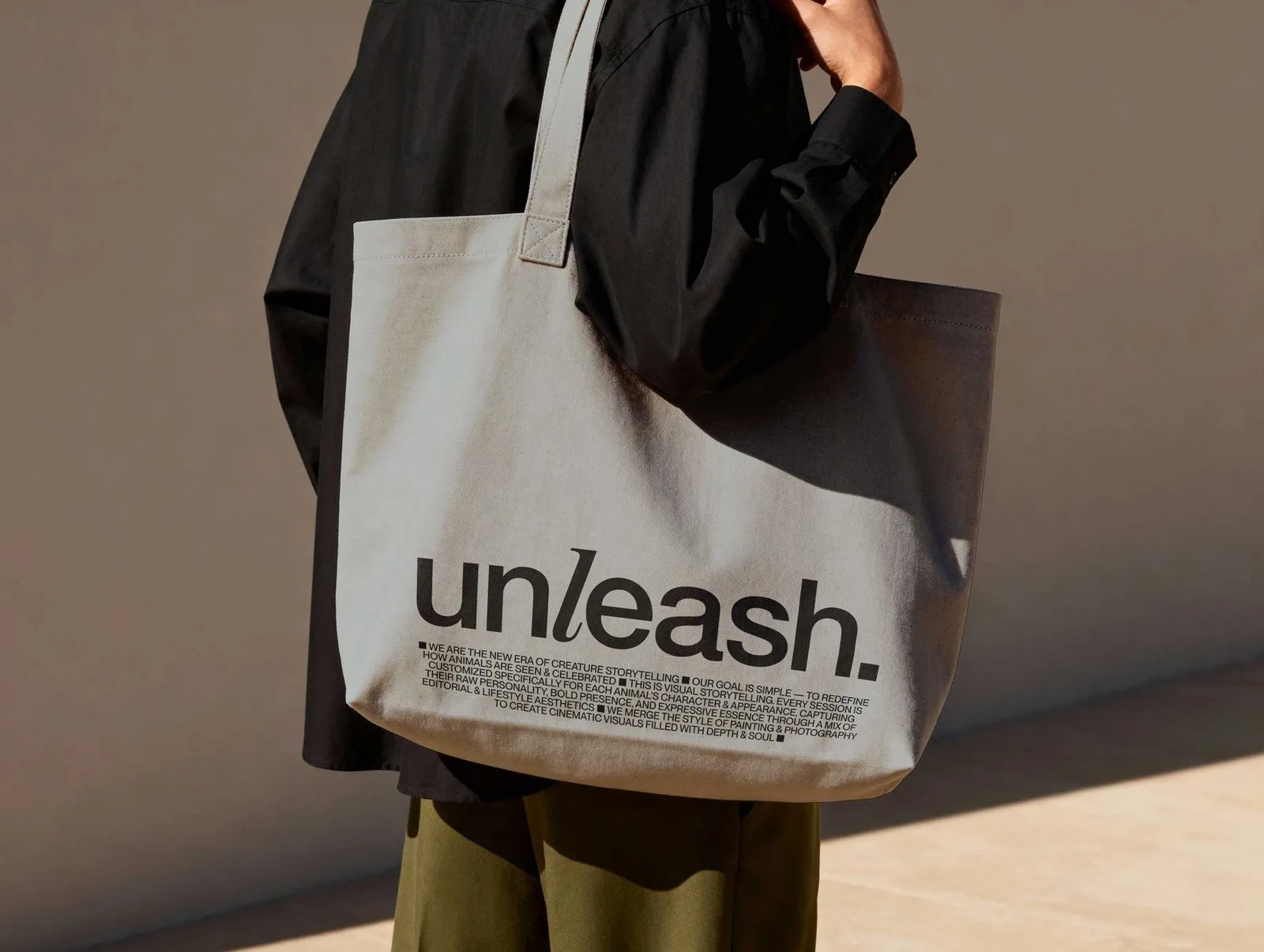 Image 3: Unleash pet storytelling branding canvas tote bag printed with serif wordmark and manifesto