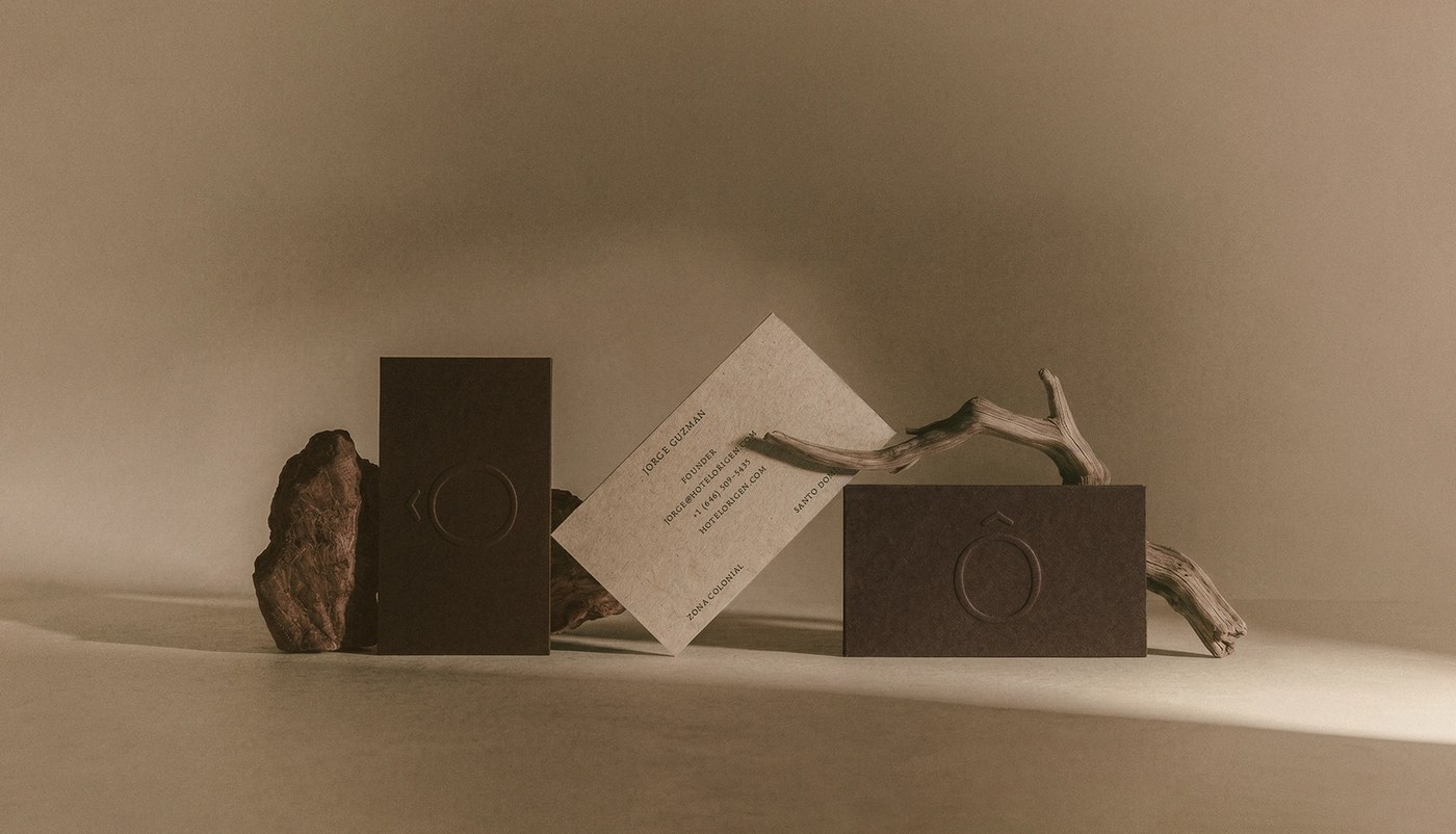Image 1: hotel rigen fugitiva .co branding business cards on a textured beige surface